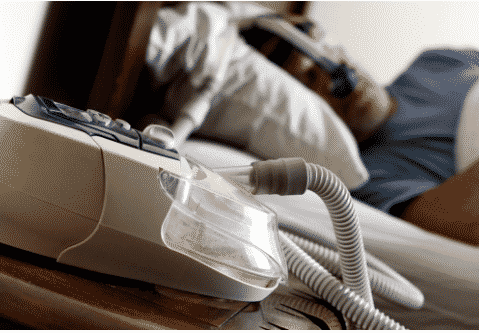 man sleeping with cpap machine